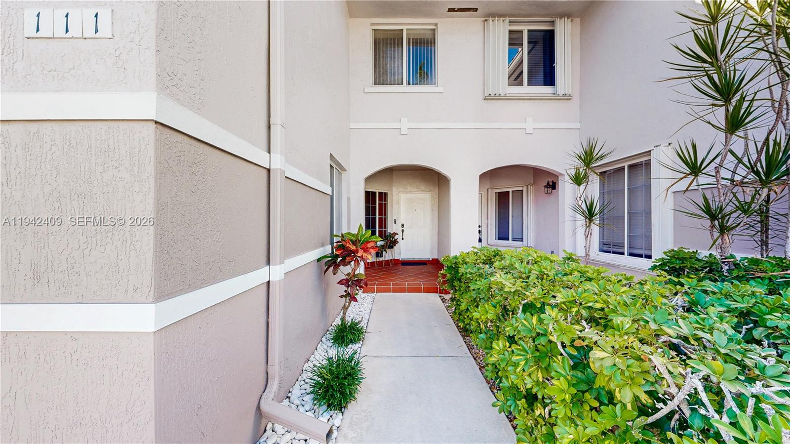 10210 Southwest 154th Place, Unit 1118 Miami, FL 33196 - Photo 3 of 71 a view of a house with a flower garden
