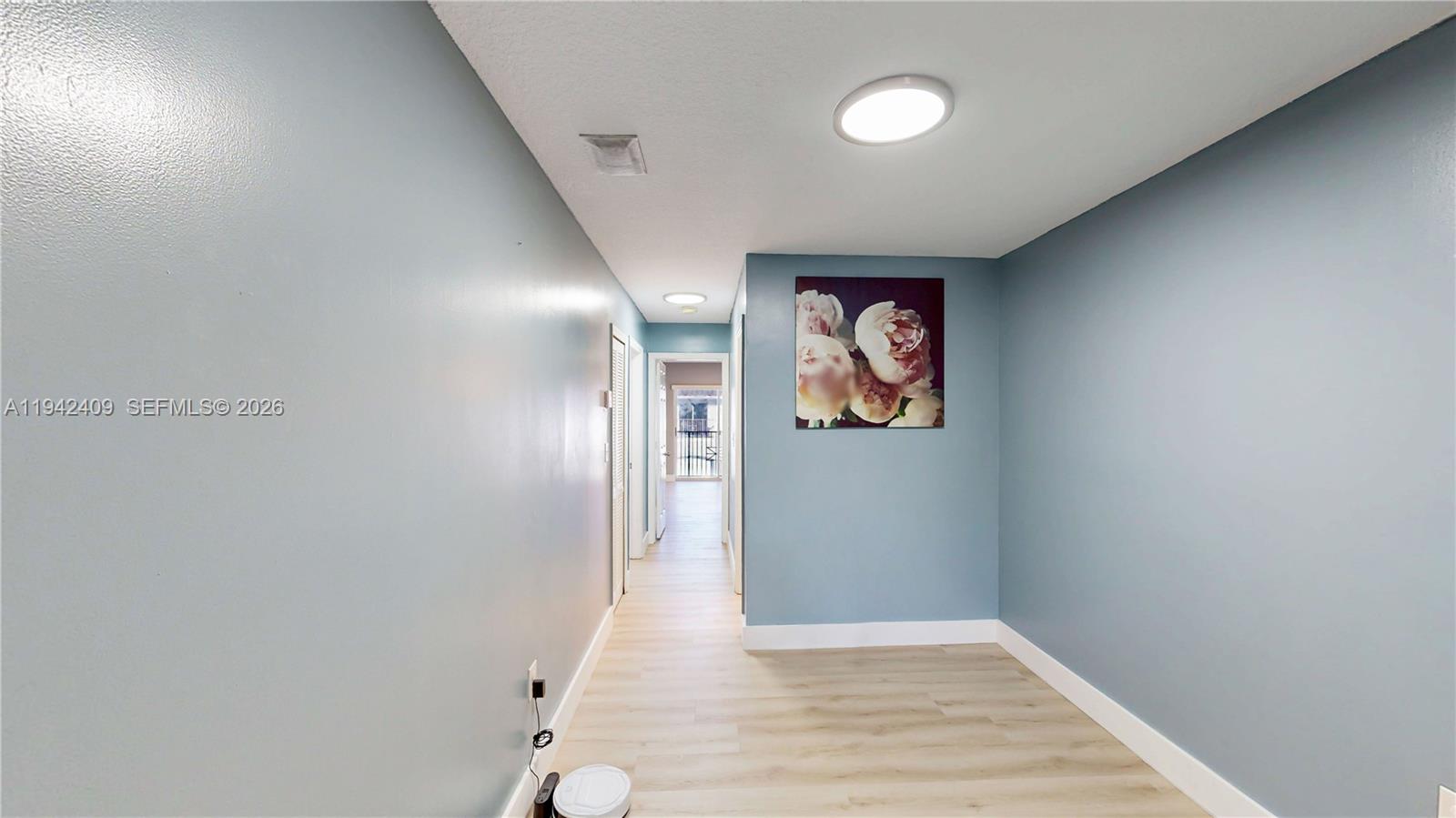 10210 Southwest 154th Place, Unit 1118 Miami, FL 33196 - Photo 31 of 59 a view of an empty room with wooden floor