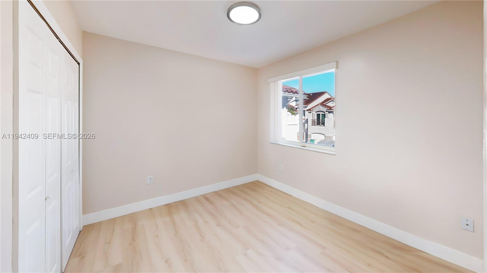 10210 Southwest 154th Place, Unit 1118 Miami, FL 33196 - Photo 32 of 59 a view of room with window and wooden floor