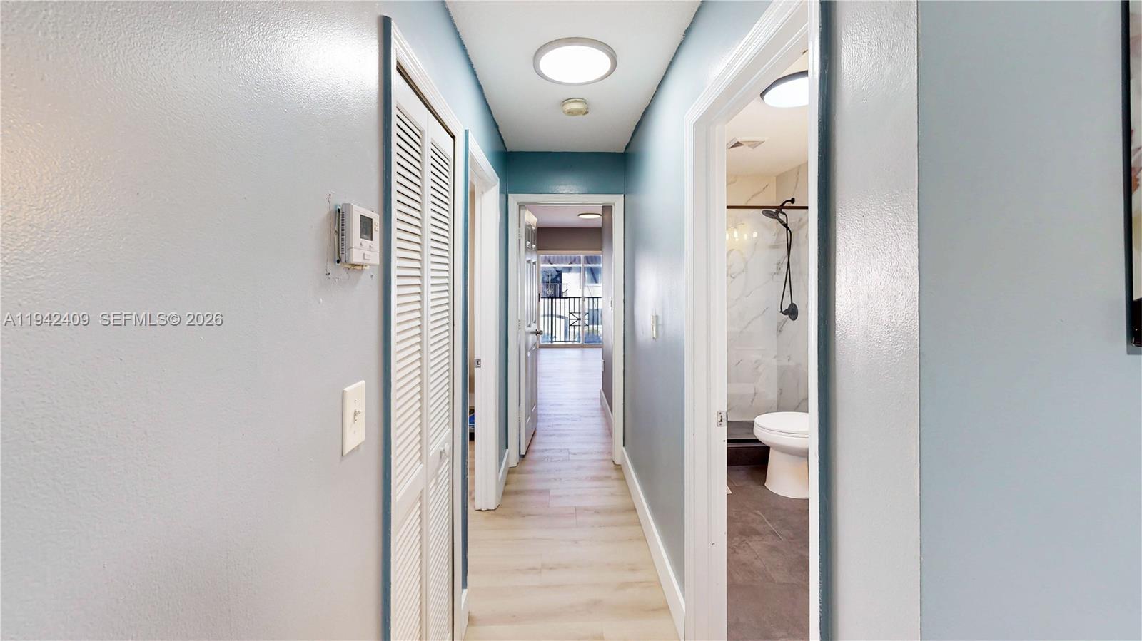 10210 Southwest 154th Place, Unit 1118 Miami, FL 33196 - Photo 35 of 59 a view of a hallway with wooden floor and entryway