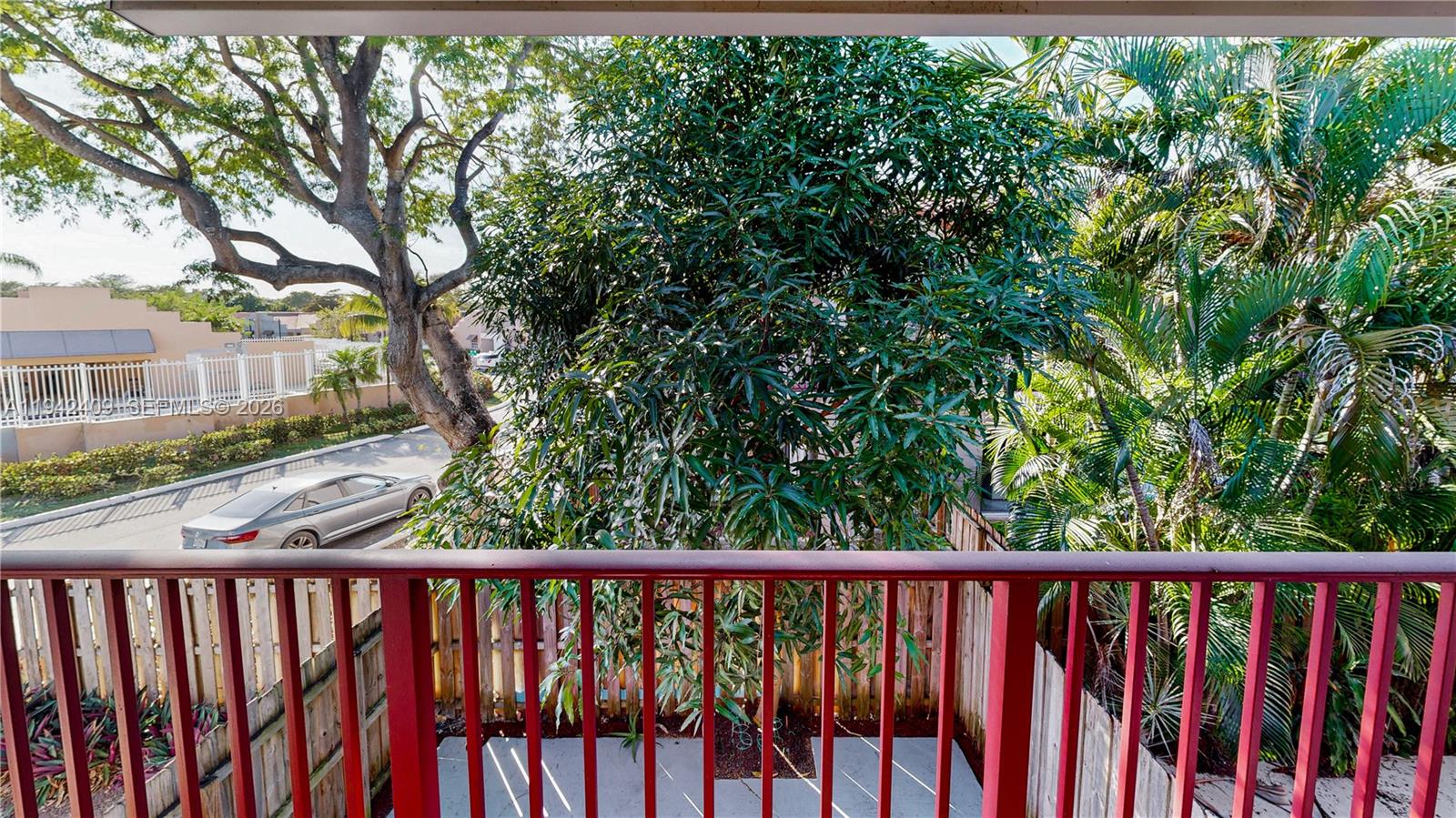 10210 Southwest 154th Place, Unit 1118 Miami, FL 33196 - Photo 35 of 71 a view of a balcony with wooden floor and fence