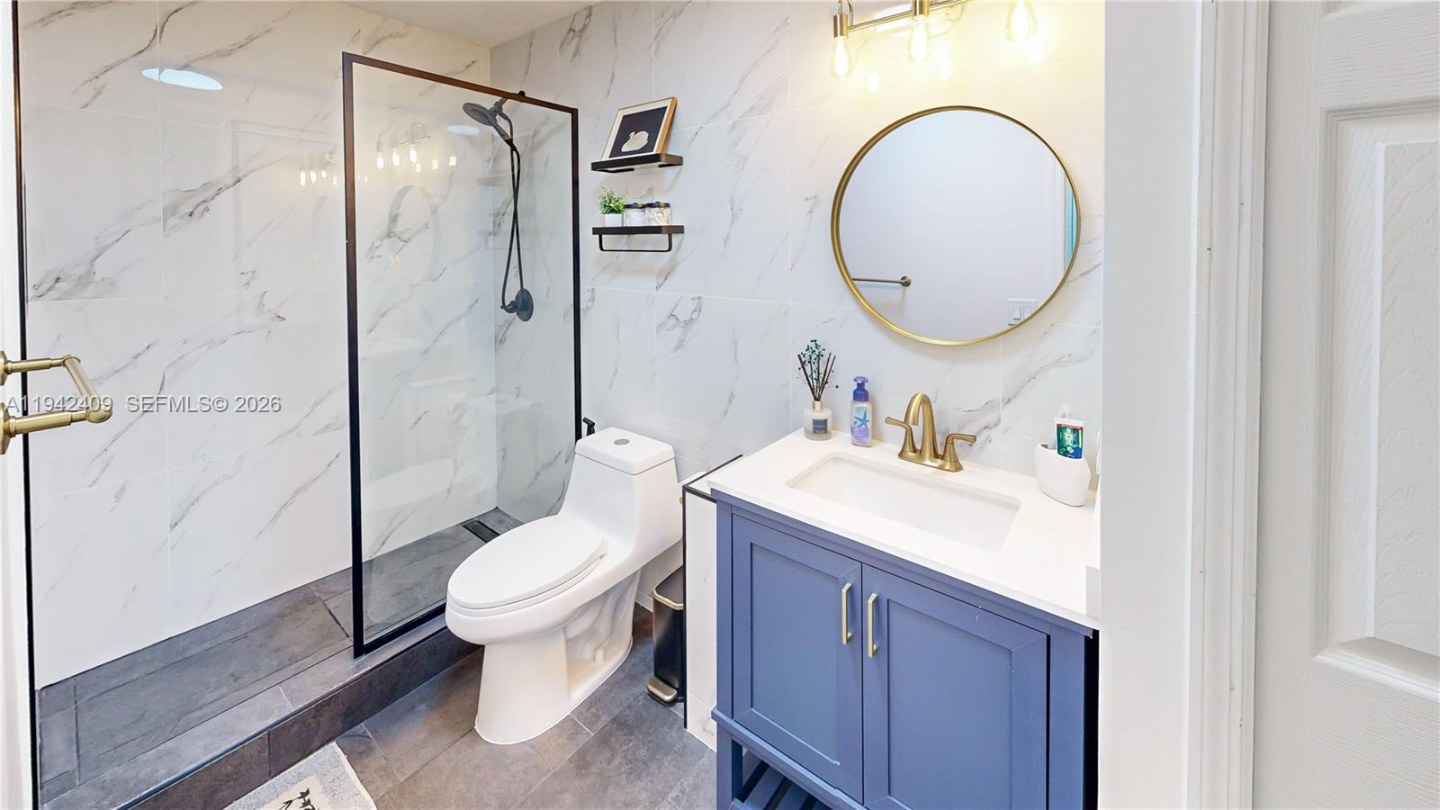 10210 Southwest 154th Place, Unit 1118 Miami, FL 33196 - Photo 36 of 59 a bathroom with a sink toilet mirror and shower