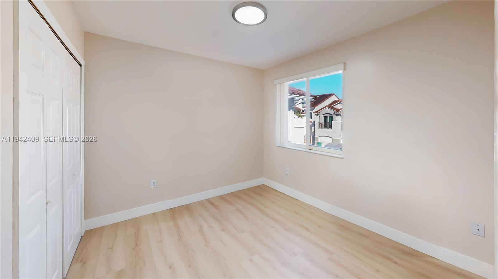 10210 Southwest 154th Place, Unit 1118 Miami, FL 33196 - Photo 38 of 71 a view of room with window and wooden floor