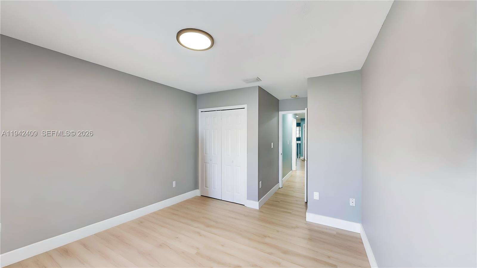 10210 Southwest 154th Place, Unit 1118 Miami, FL 33196 - Photo 40 of 59 a view of an empty room with wooden floor