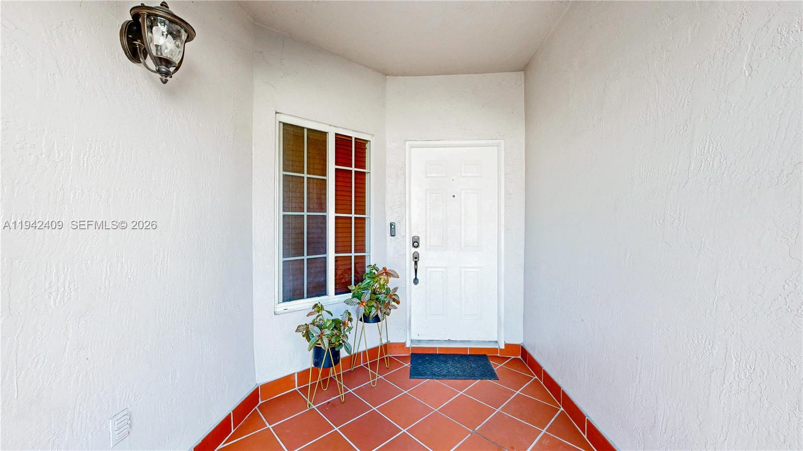 10210 Southwest 154th Place, Unit 1118 Miami, FL 33196 - Photo 4 of 71 a room with a potted plant and a wall painting