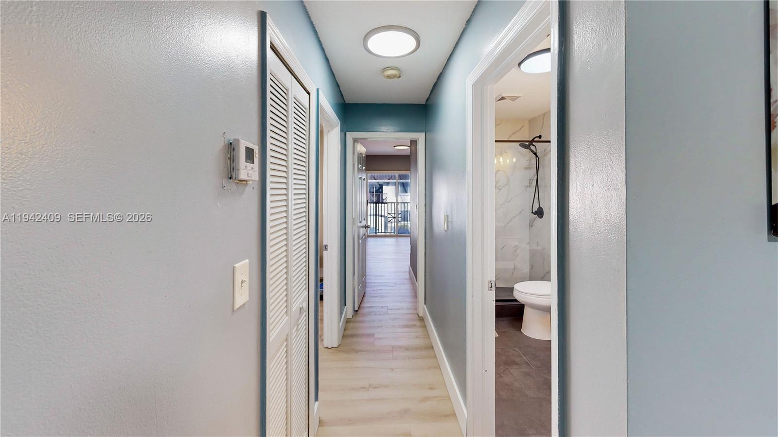 10210 Southwest 154th Place, Unit 1118 Miami, FL 33196 - Photo 41 of 71 a view of a hallway with wooden floor and staircase