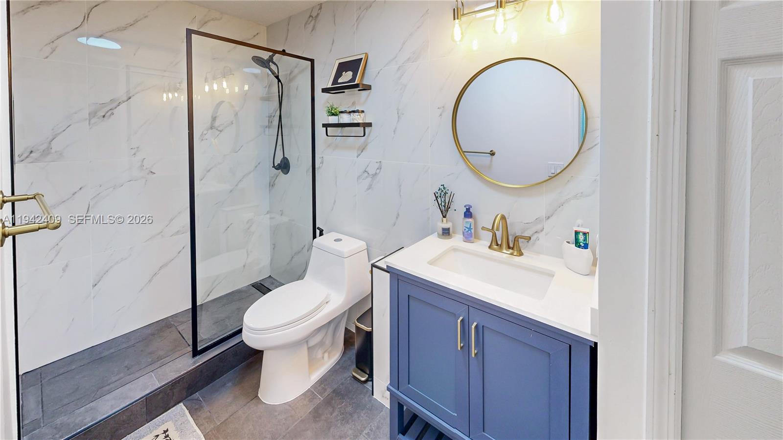 10210 Southwest 154th Place, Unit 1118 Miami, FL 33196 - Photo 42 of 71 a bathroom with a sink toilet mirror and shower