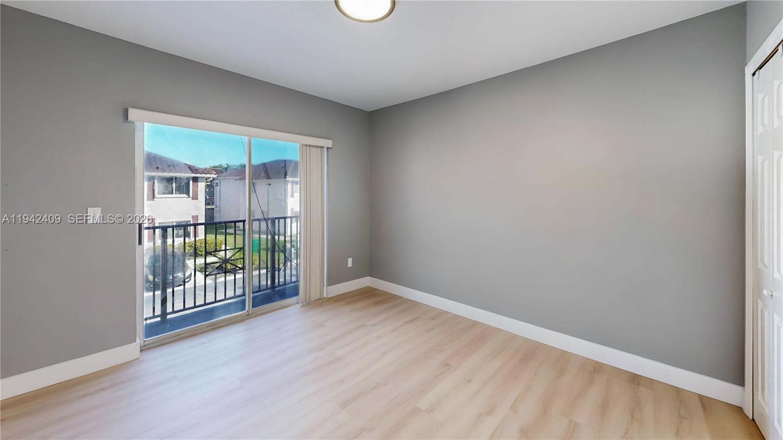 10210 Southwest 154th Place, Unit 1118 Miami, FL 33196 - Photo 44 of 71 wooden floor and window in an empty room