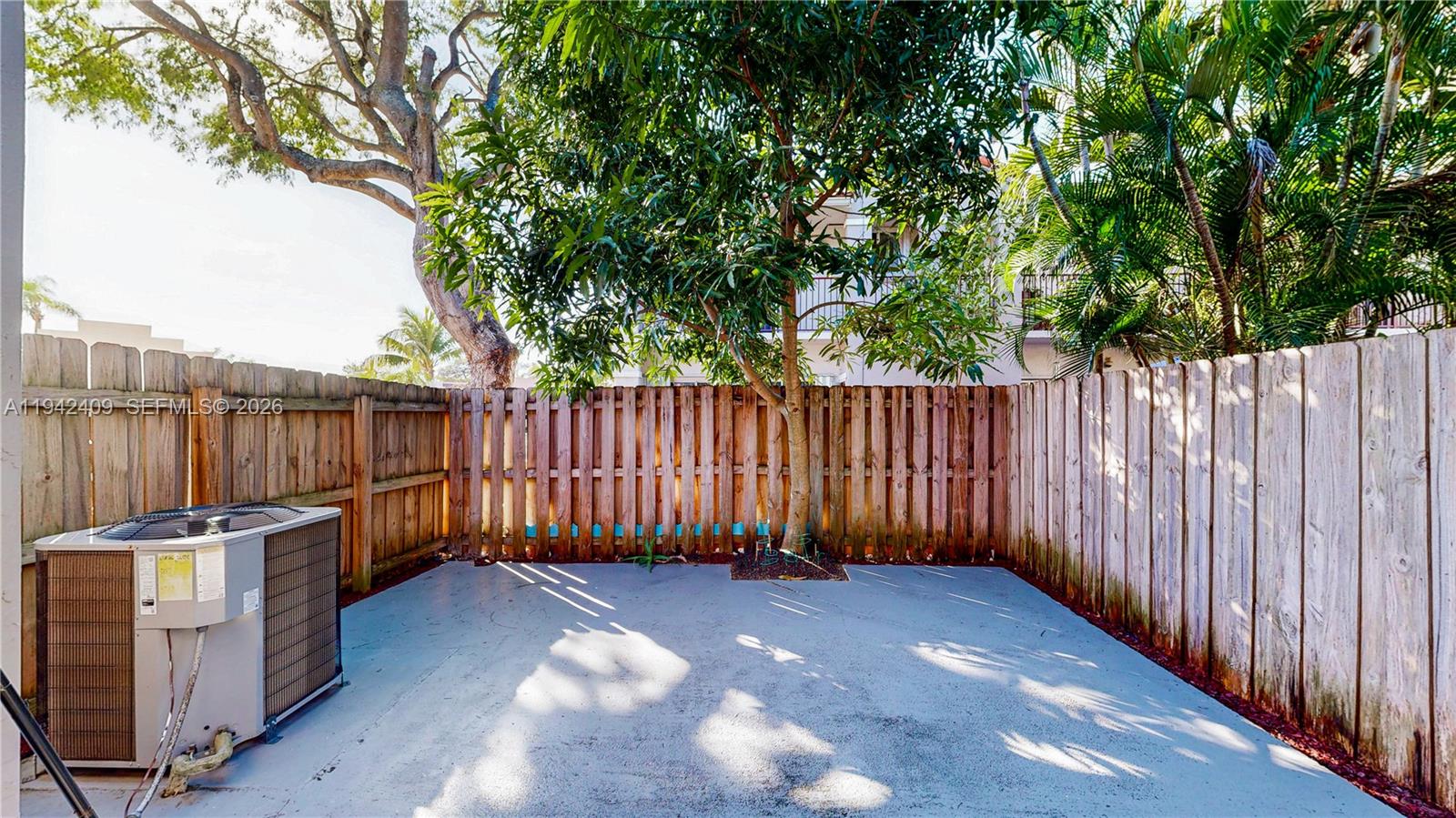 10210 Southwest 154th Place, Unit 1118 Miami, FL 33196 - Photo 47 of 71 a view of a backyard with wooden fence