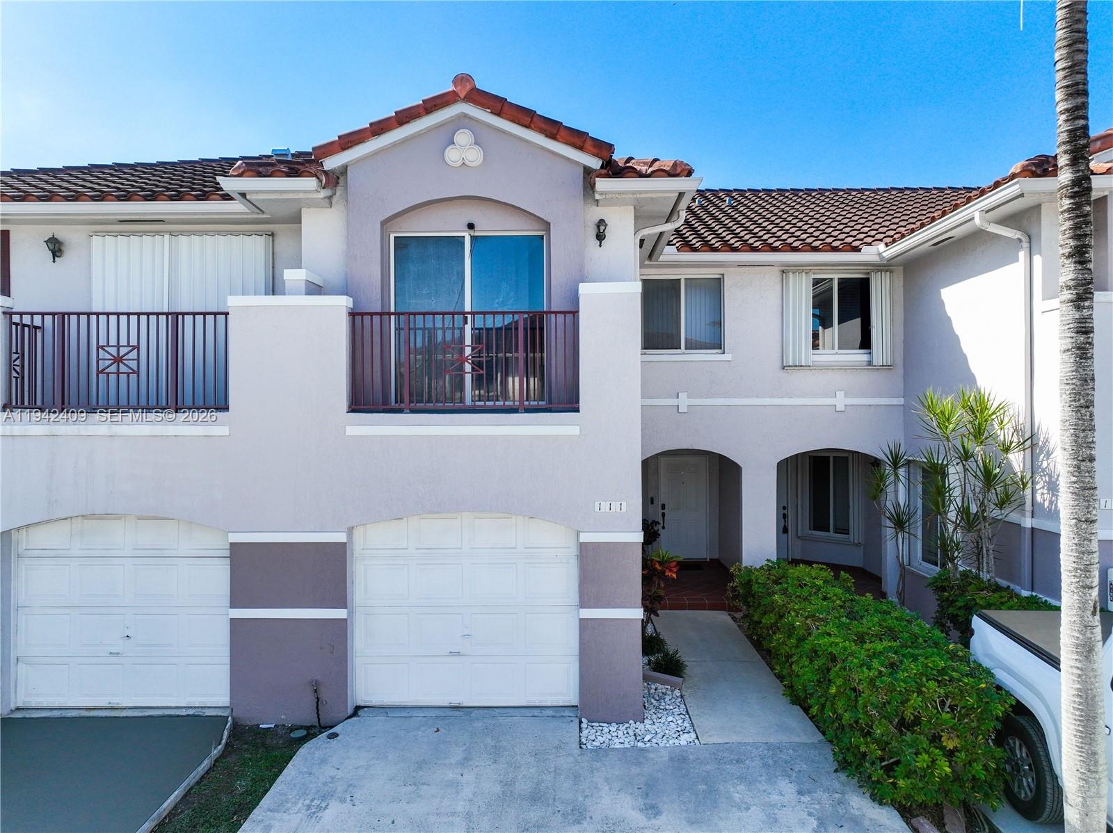 10210 Southwest 154th Place, Unit 1118 Miami, FL 33196 - Photo 48 of 59 a front view of a house with a yard
