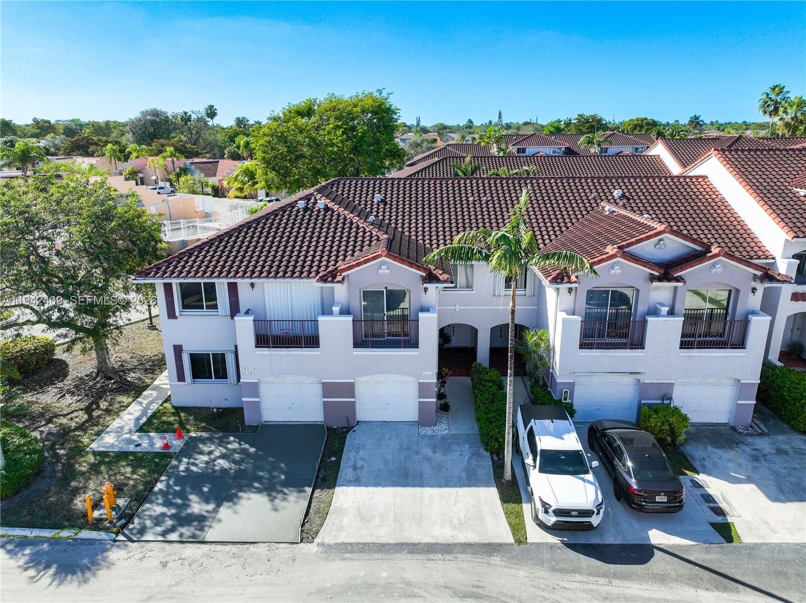10210 Southwest 154th Place, Unit 1118 Miami, FL 33196 - Photo 51 of 59 a front view of a house with garden
