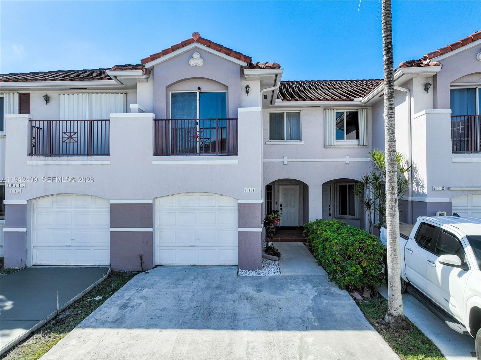 10210 Southwest 154th Place, Unit 1118 Miami, FL 33196 - Photo 56 of 71 a front view of a house with garden