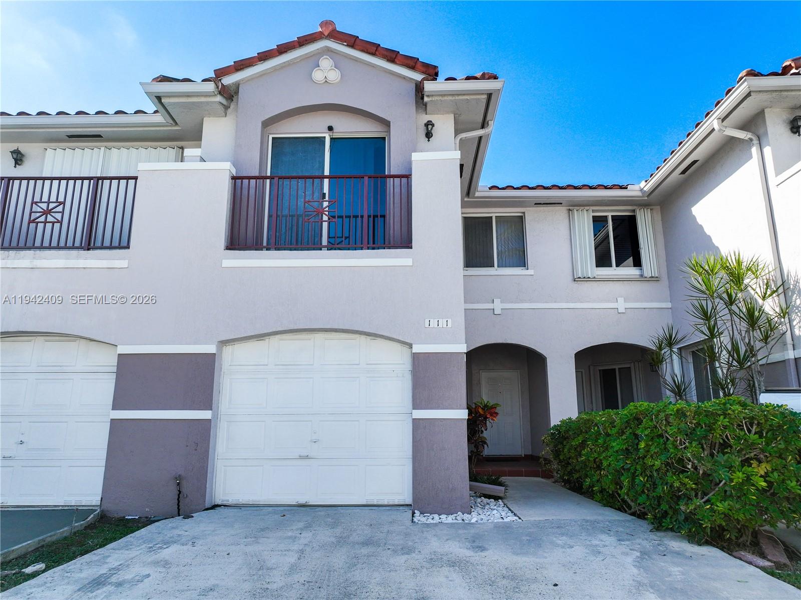 10210 Southwest 154th Place, Unit 1118 Miami, FL 33196 - Photo 57 of 71 a front view of a house with a garage