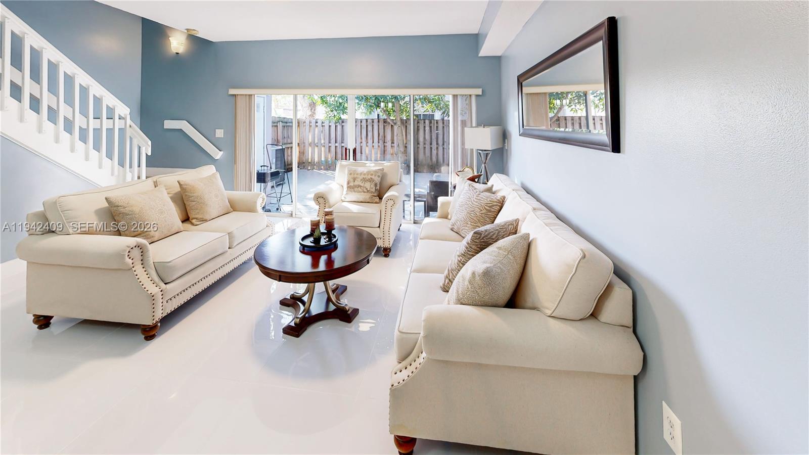 10210 Southwest 154th Place, Unit 1118 Miami, FL 33196 - Photo 6 of 59 a living room with furniture and a large window