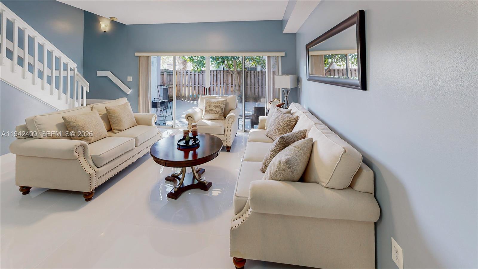 10210 Southwest 154th Place, Unit 1118 Miami, FL 33196 - Photo 6 of 71 a living room with furniture and a large window