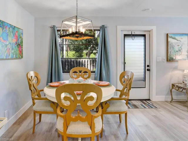 a dining room with furniture and wooden floor