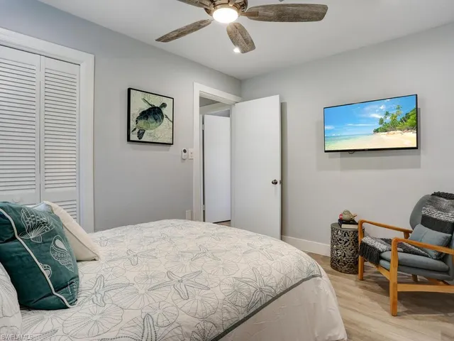 a bathroom with a granite countertop sink a toilet and shower