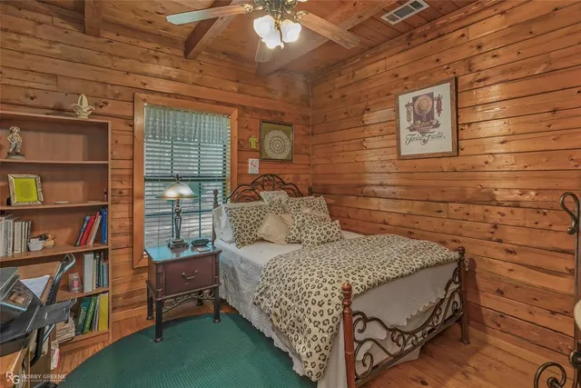 a bedroom with a bed and a book shelf