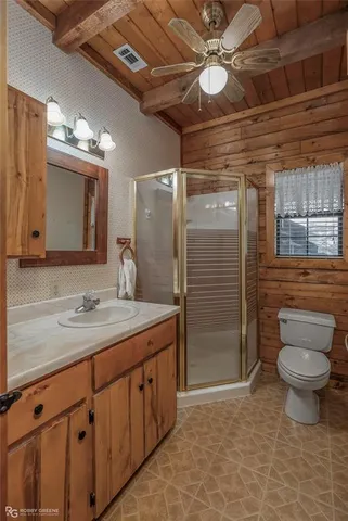 a bathroom with a toilet sink and shower
