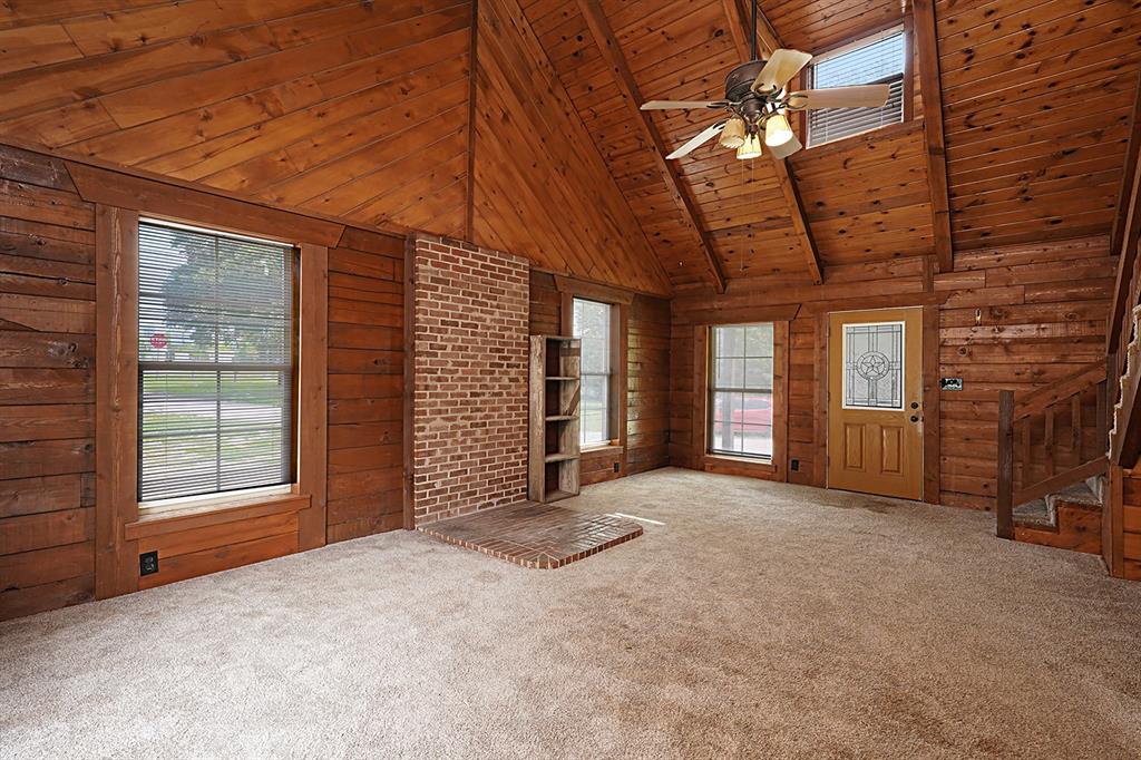 371 Spring Street Forestburg, TX 76239 - Photo 8 of 38 a view of an empty room with a fireplace and windows