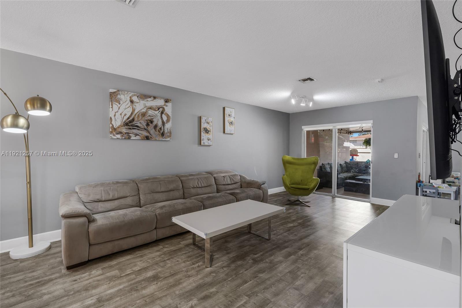 4055 Eastridge Drive Deerfield Beach, FL 33064 - Photo 11 of 56 a living room with furniture and a wooden floor