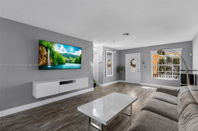 a kitchen with granite countertop a stove top oven a sink dishwasher a dining table and chairs