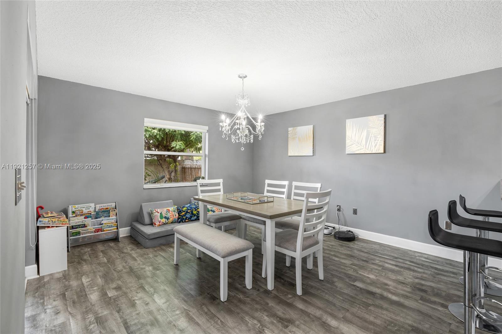 4055 Eastridge Drive Deerfield Beach, FL 33064 - Photo 20 of 56 a view of a dining room with furniture a chandelier and wooden floor
