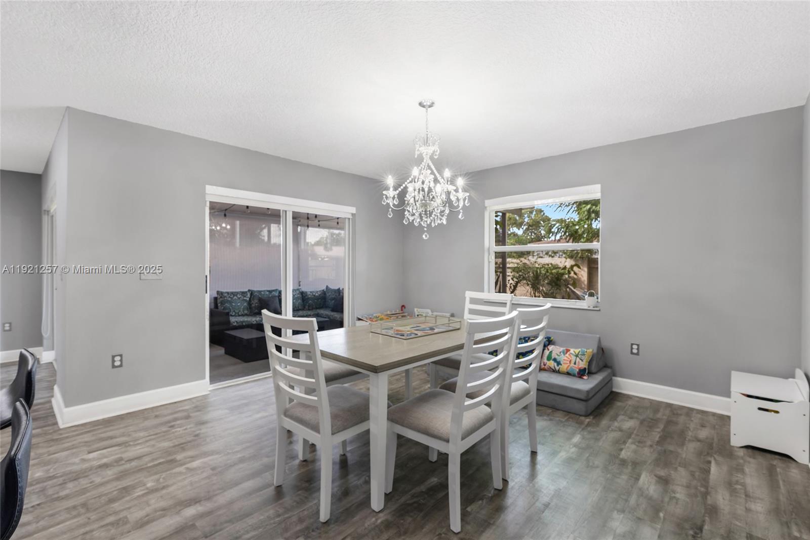 4055 Eastridge Drive Deerfield Beach, FL 33064 - Photo 21 of 56 a view of a dining room with furniture and chandelier