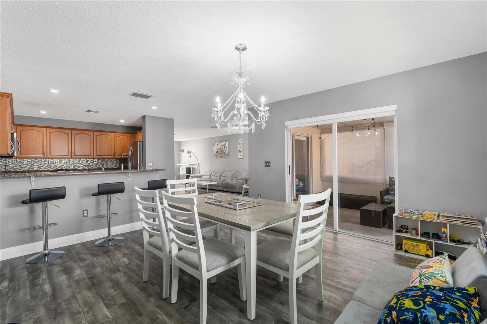 4055 Eastridge Drive Deerfield Beach, FL 33064 - Photo 22 of 56 a view of a dining room with furniture window and wooden floor