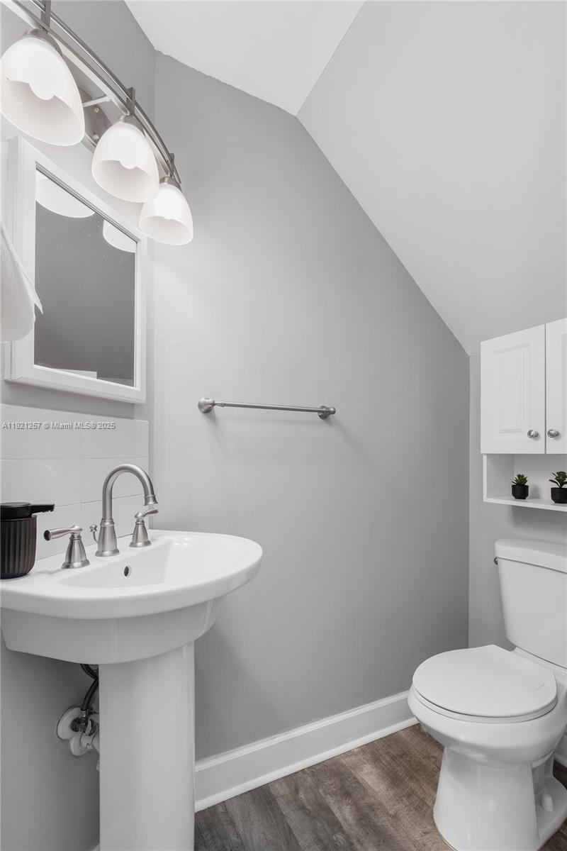 4055 Eastridge Drive Deerfield Beach, FL 33064 - Photo 23 of 56 a bathroom with a sink a mirror and a toilet