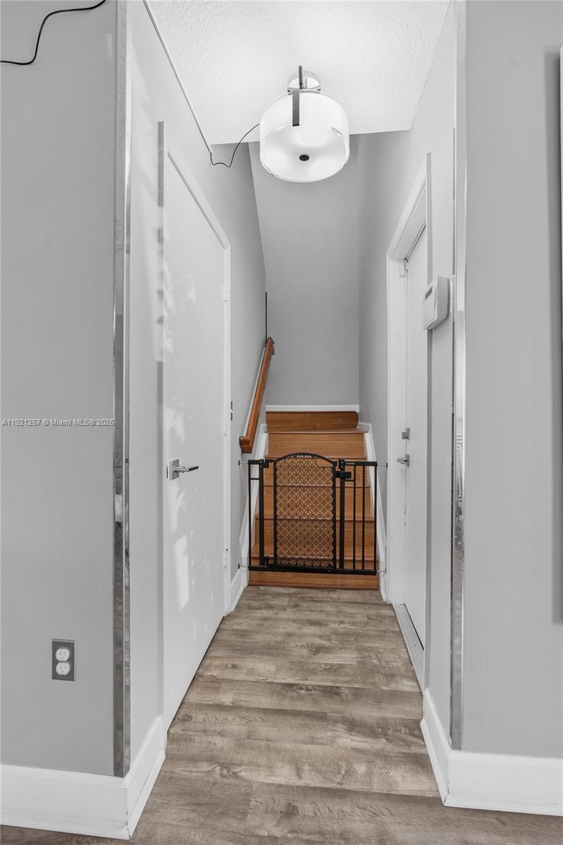4055 Eastridge Drive Deerfield Beach, FL 33064 - Photo 24 of 56 a view of a hallway with wooden floor and staircase