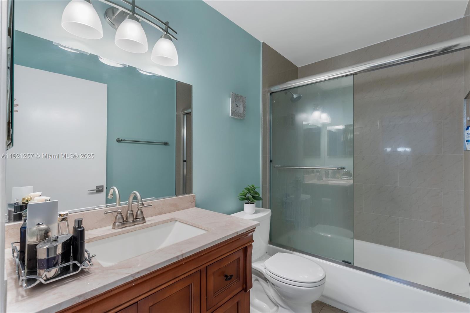 4055 Eastridge Drive Deerfield Beach, FL 33064 - Photo 31 of 56 a bathroom with a sink a toilet and shower