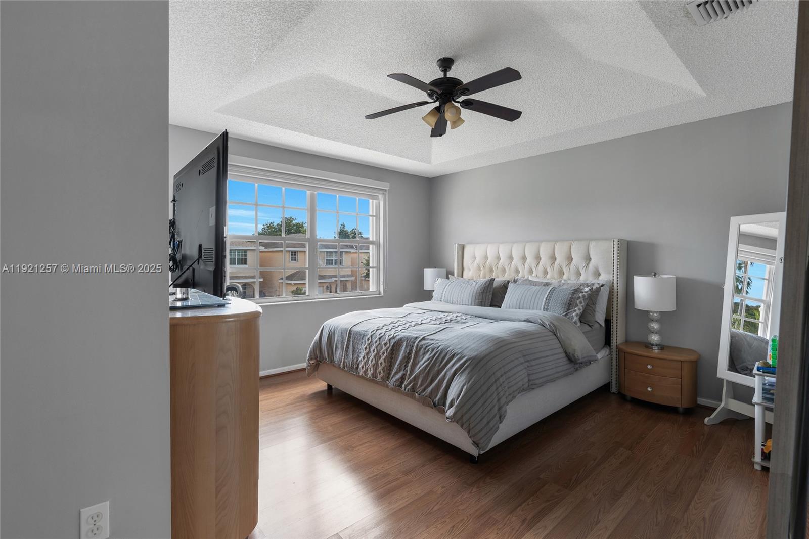 4055 Eastridge Drive Deerfield Beach, FL 33064 - Photo 32 of 56 a bedroom with a bed and a chandelier