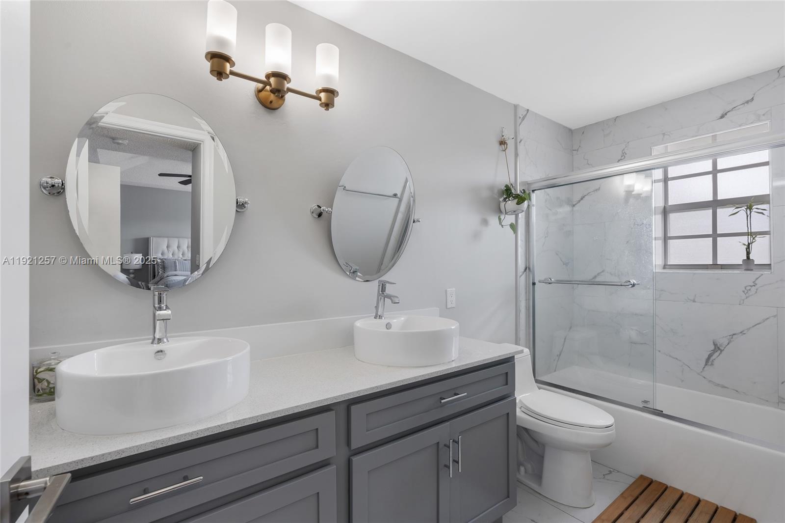 4055 Eastridge Drive Deerfield Beach, FL 33064 - Photo 35 of 56 a bathroom with a toilet sink and mirror