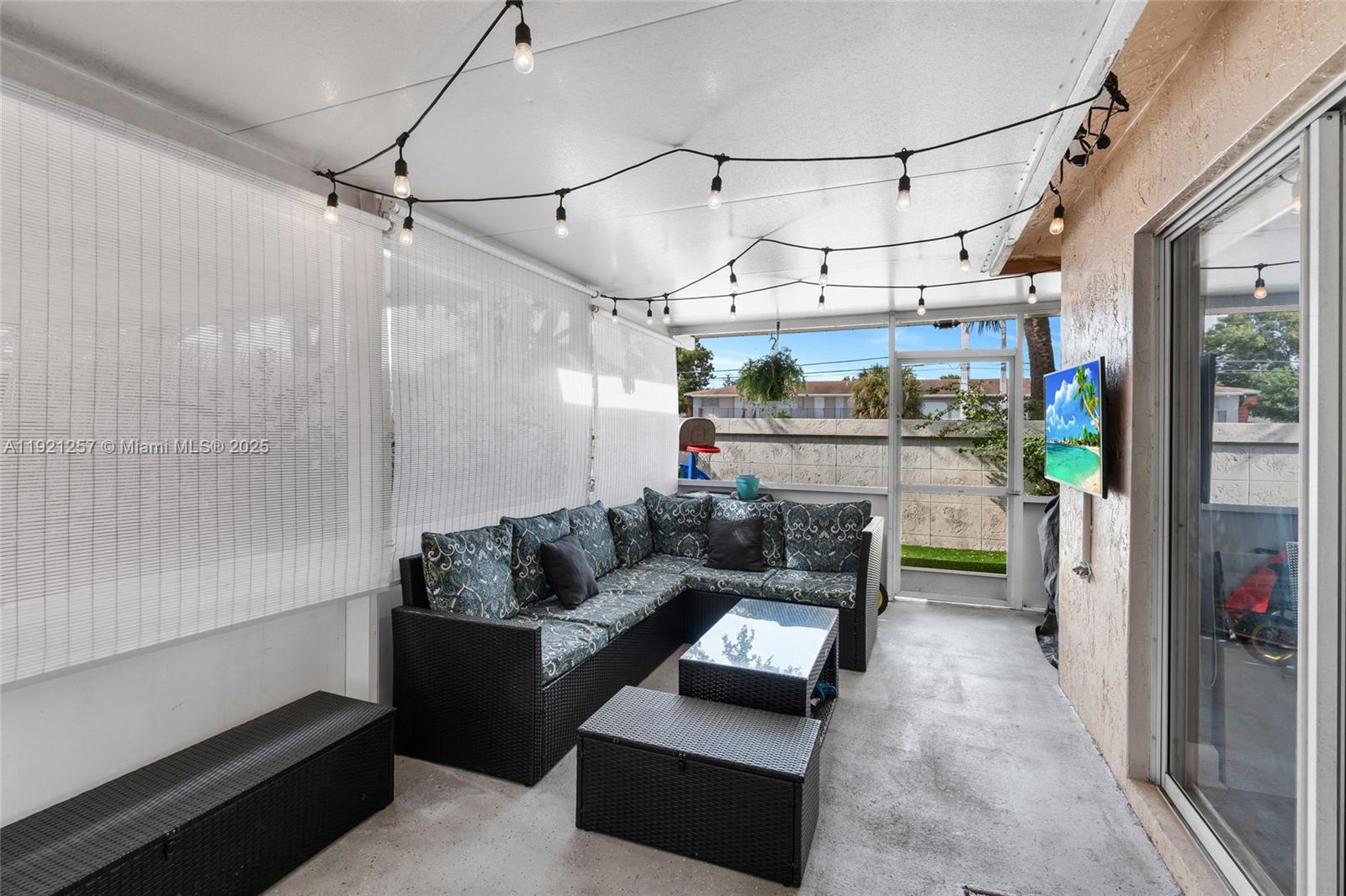 4055 Eastridge Drive Deerfield Beach, FL 33064 - Photo 39 of 56 a living room with furniture and a chandelier