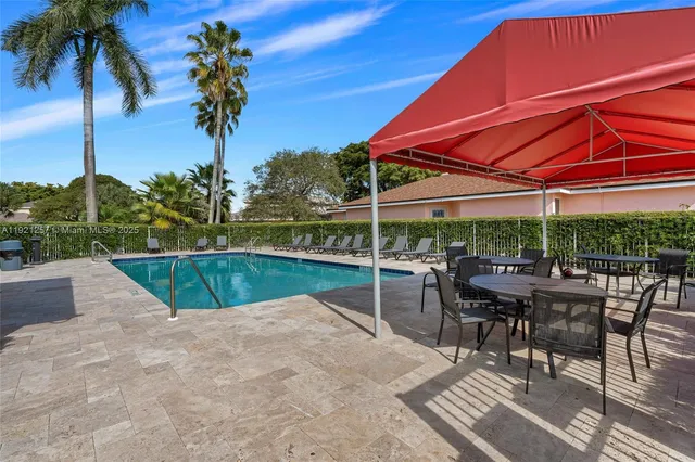 a view of a swimming pool and lounge chairs