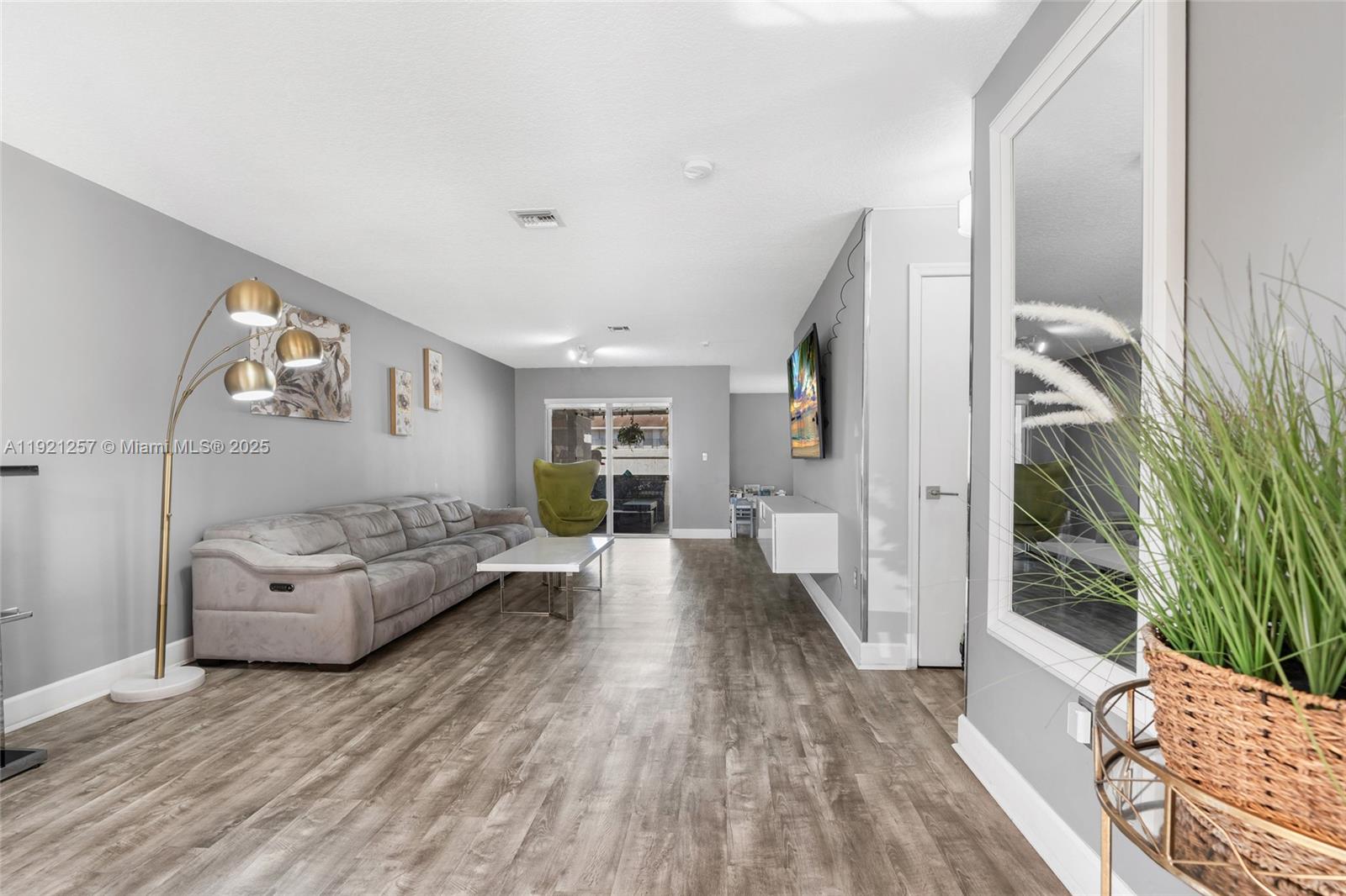 4055 Eastridge Drive Deerfield Beach, FL 33064 - Photo 8 of 56 a living room with furniture and a wooden floor