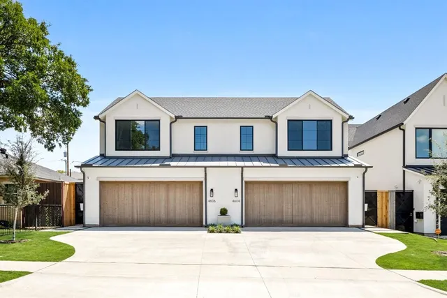 a front view of a house with yard and garage