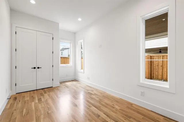 a view of a kitchen with cabinets and wooden floor