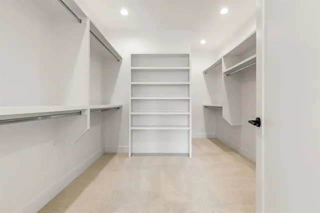 a bathroom with a double vanity sink mirror and shower