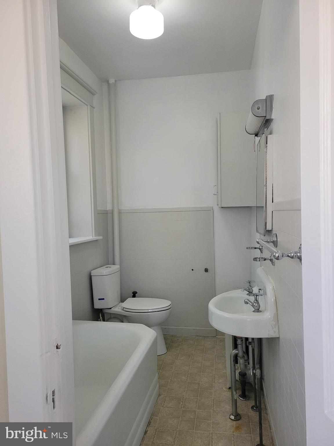 1517 North 13th Street Reading, PA 19604 - Photo 17 of 18 a bathroom with a sink a toilet and a mirror