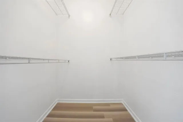 a bathroom with a granite countertop toilet a sink and a mirror