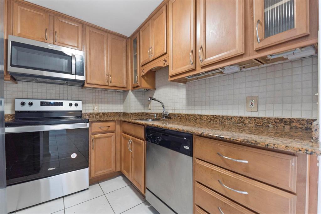 1625 Southeast 10th Avenue, Unit 508 Fort Lauderdale, FL 33316 - Photo 4 of 22 a kitchen with stainless steel appliances granite countertop a sink stove and microwave