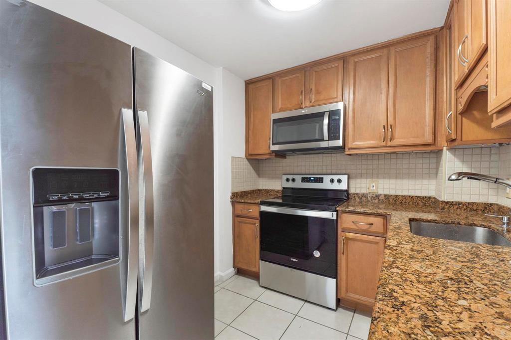 1625 Southeast 10th Avenue, Unit 508 Fort Lauderdale, FL 33316 - Photo 5 of 22 a kitchen with stainless steel appliances granite countertop a refrigerator and a stove top oven