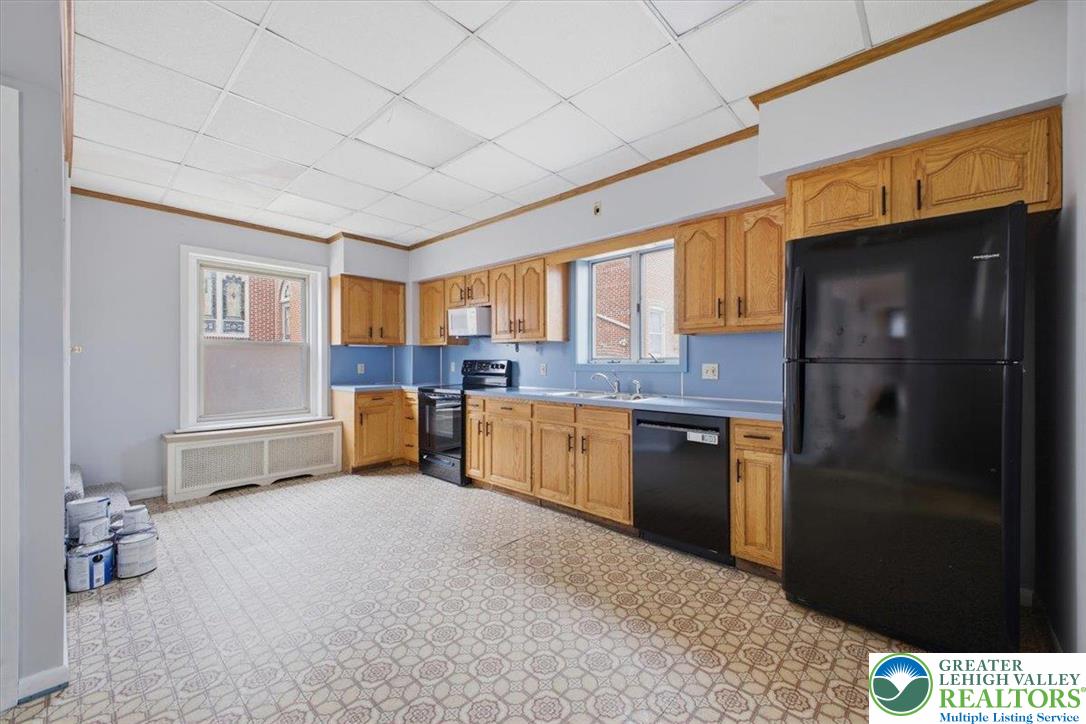 1229 Main Street Northampton, PA 18067 - Photo 13 of 24 a kitchen with stainless steel appliances kitchen island granite countertop a refrigerator and a stove top oven