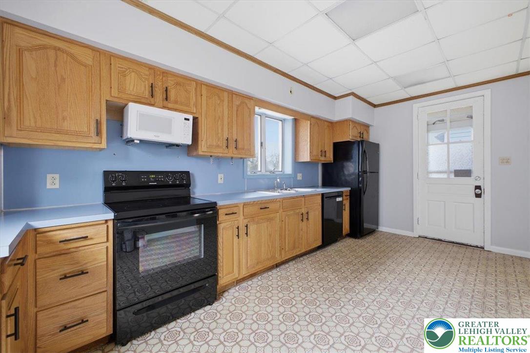 1229 Main Street Northampton, PA 18067 - Photo 14 of 24 a kitchen with stainless steel appliances granite countertop a refrigerator and a stove top oven