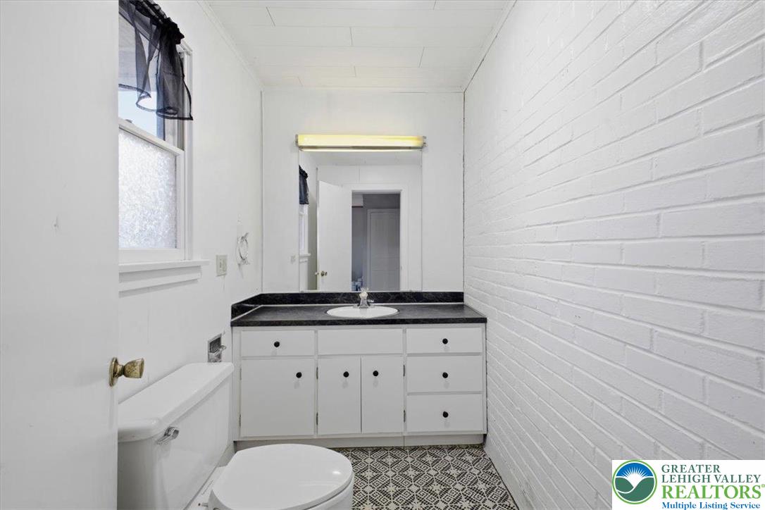 1229 Main Street Northampton, PA 18067 - Photo 15 of 24 a bathroom with a granite countertop toilet sink and mirror