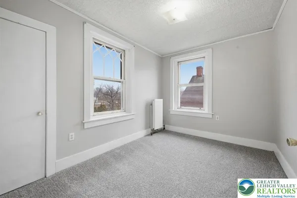 a view of an empty room with a window