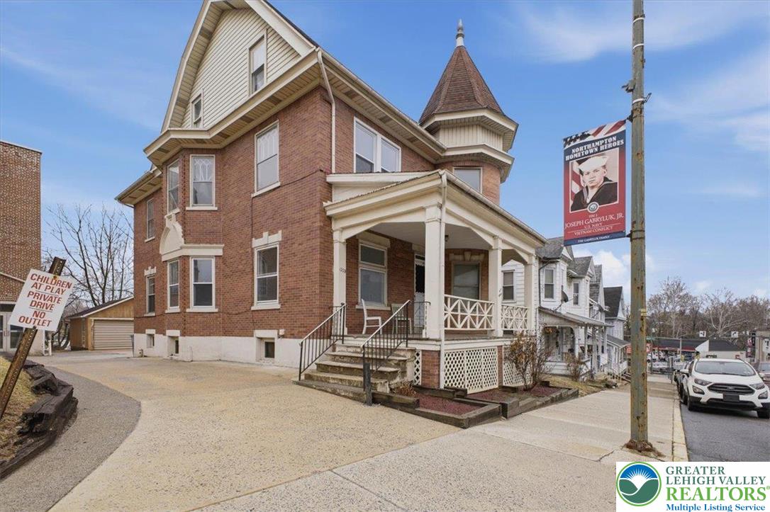 1229 Main Street Northampton, PA 18067 - Photo 2 of 24 a front view of a building with parked cars