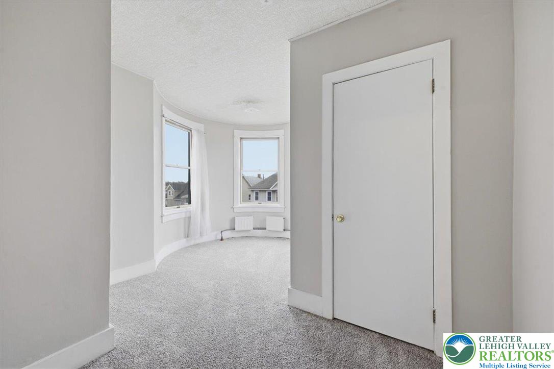 1229 Main Street Northampton, PA 18067 - Photo 22 of 24 a view of a hallway with a livingroom and a bathroom with sink